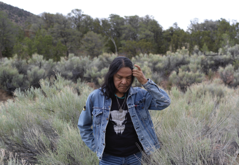 Local Santa Fe artist Darren Vigil Gray stands in the New Mexico brushlands
